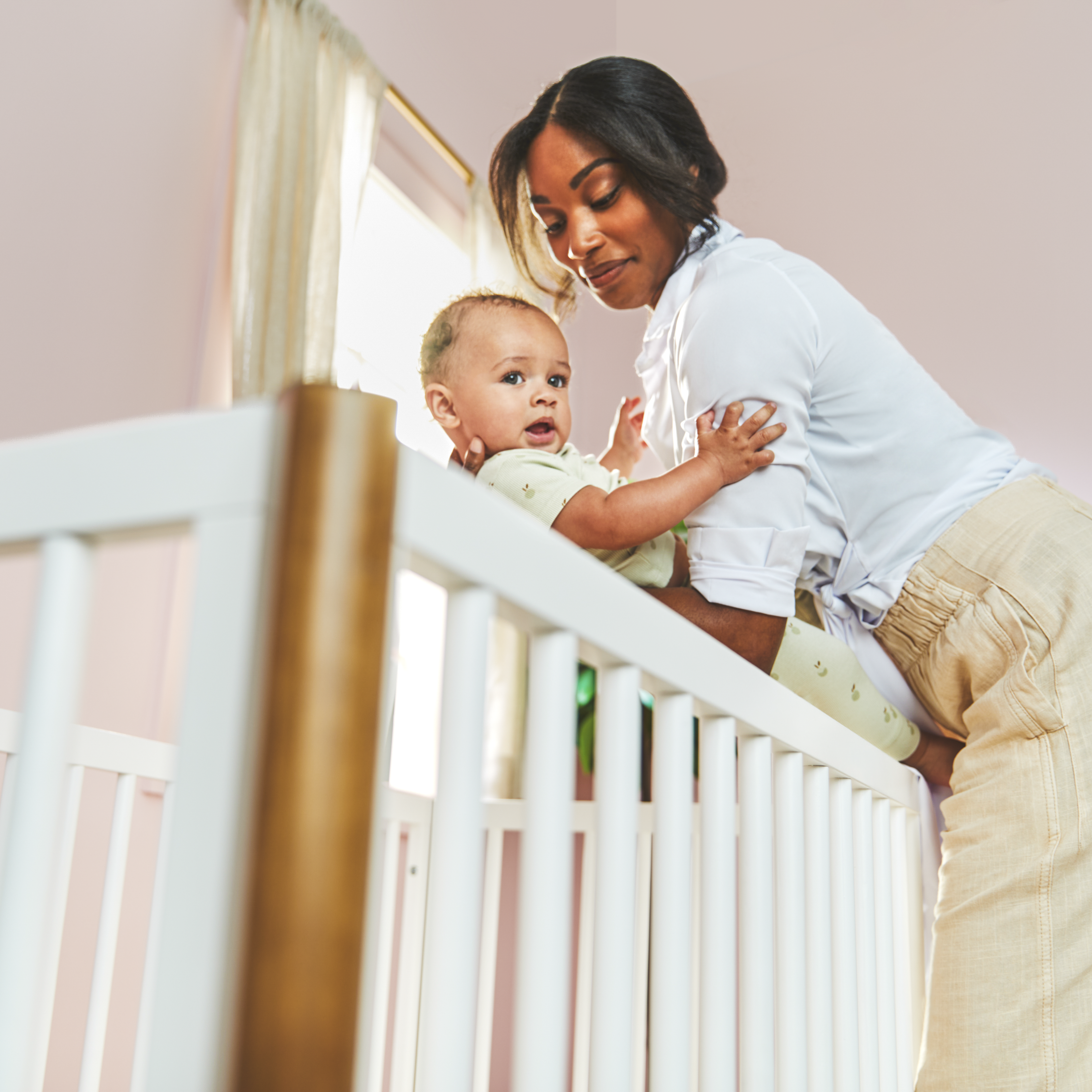 Laurel 4-in-1 Convertible Crib - mother picking baby up out of crib