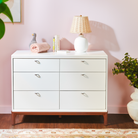 Laurel 6-Drawer Double Dresser with lamp, books, and other items on top